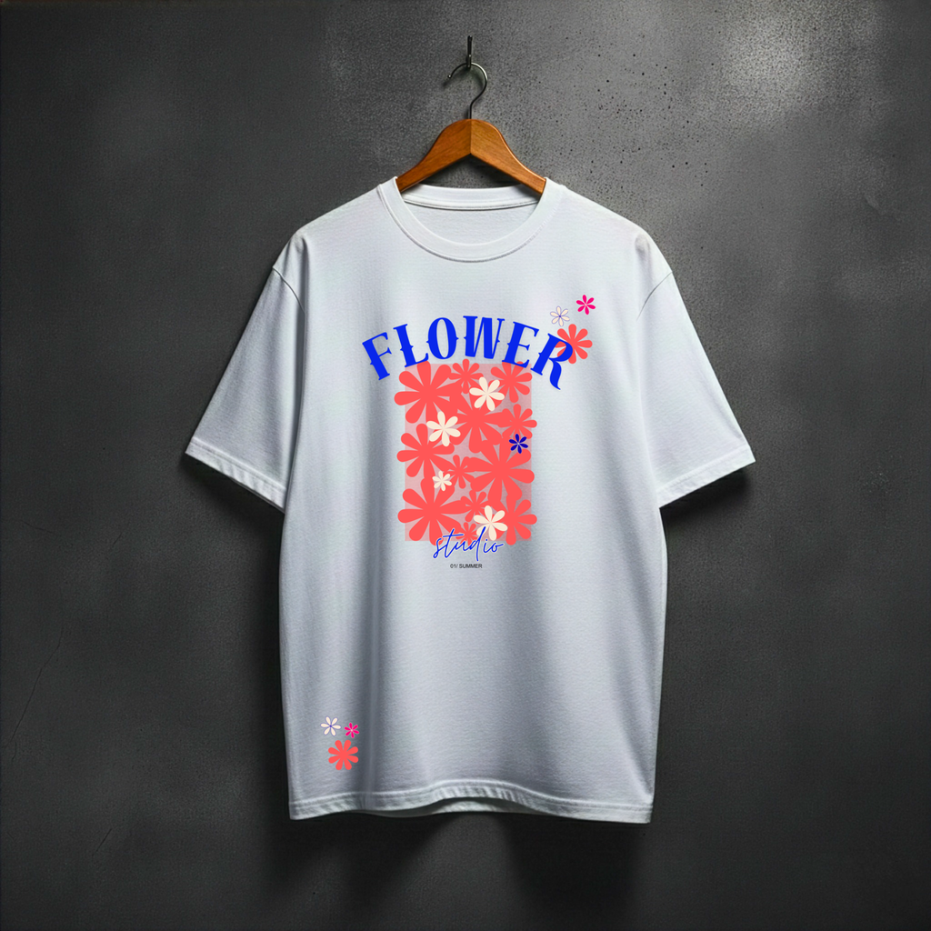 White t-shirt with colorful floral design and text on a hanger against a dark background