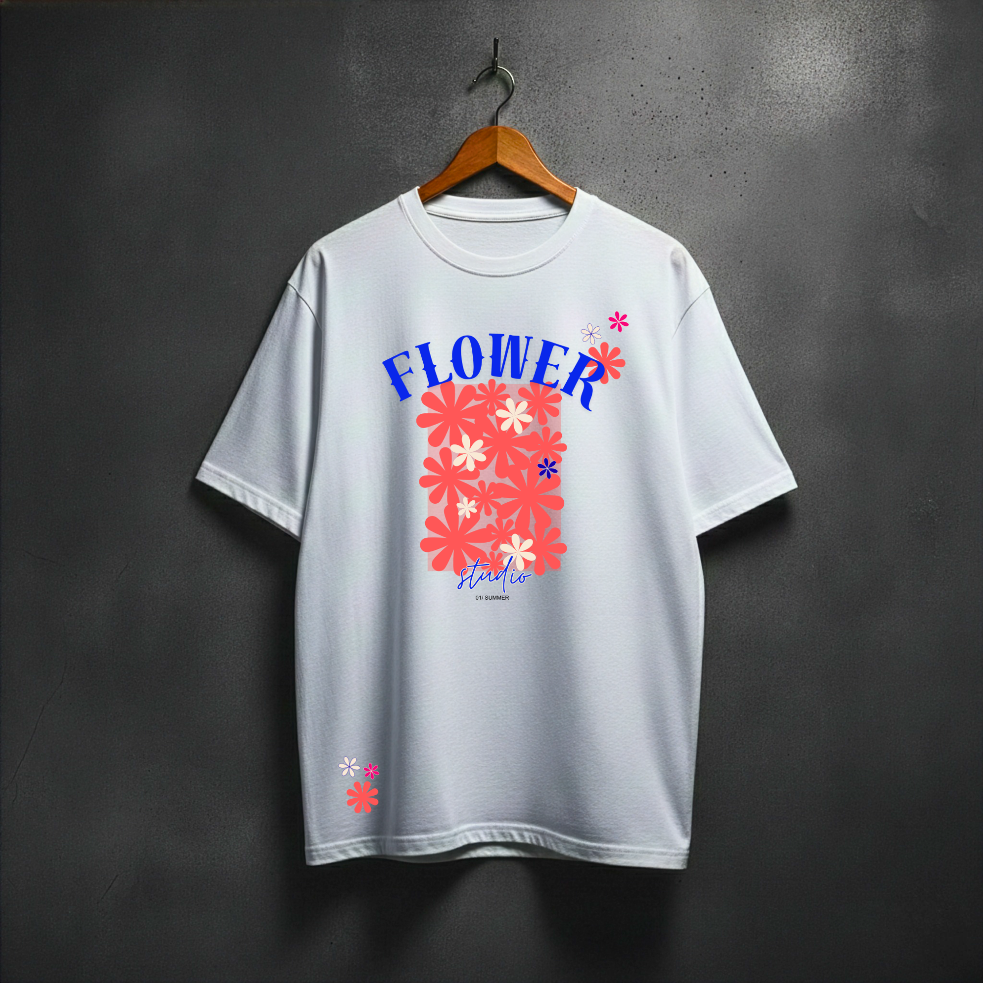 White t-shirt with colorful floral design and text on a hanger against a dark background