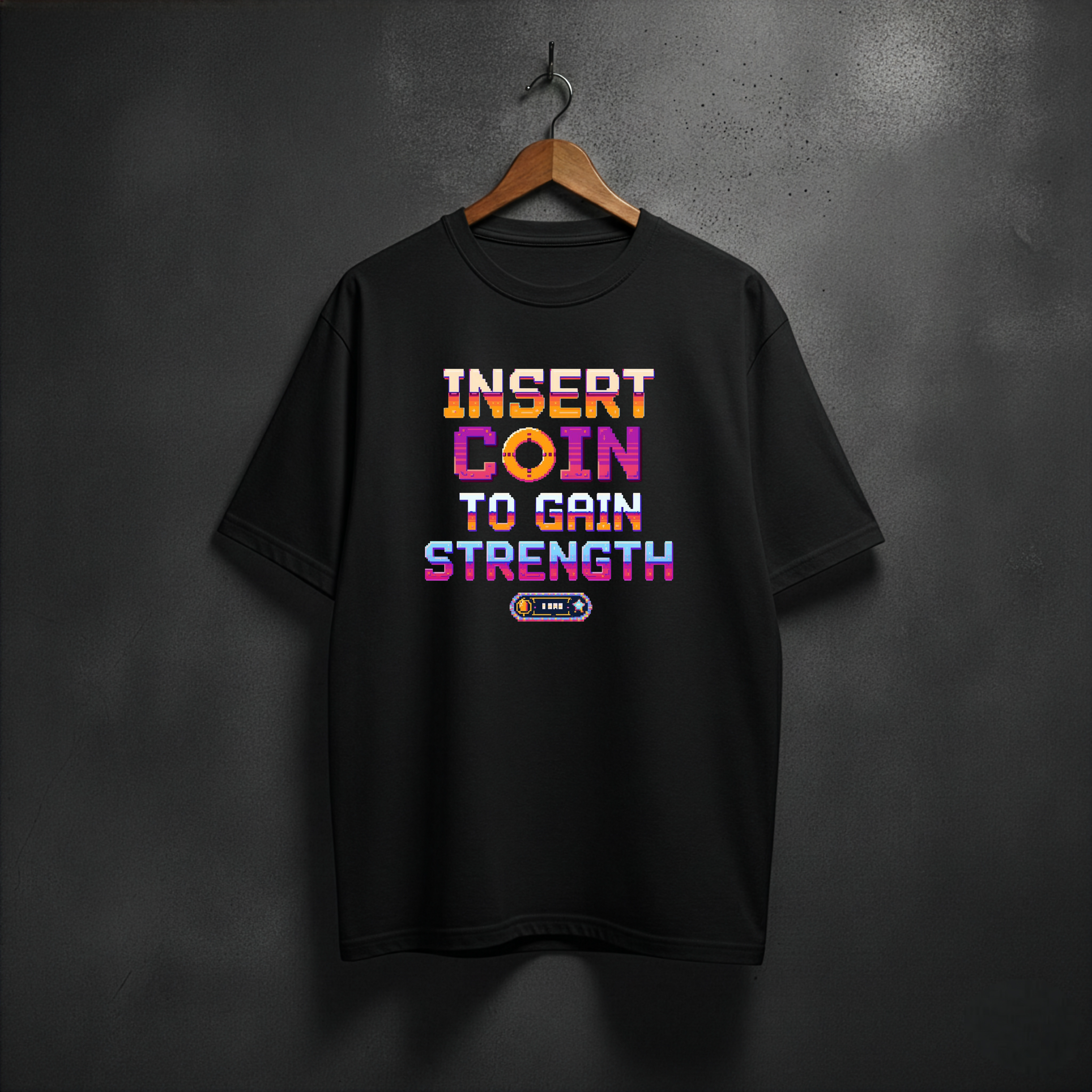 Black T-shirt with arcade style text INSERT COIN TO GAIN STRENGHT on the fron 
