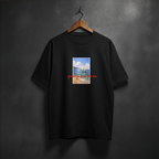 Black t-shirt with a graphic design of a sailboat and text 'greetings from the sea' on the front chest
