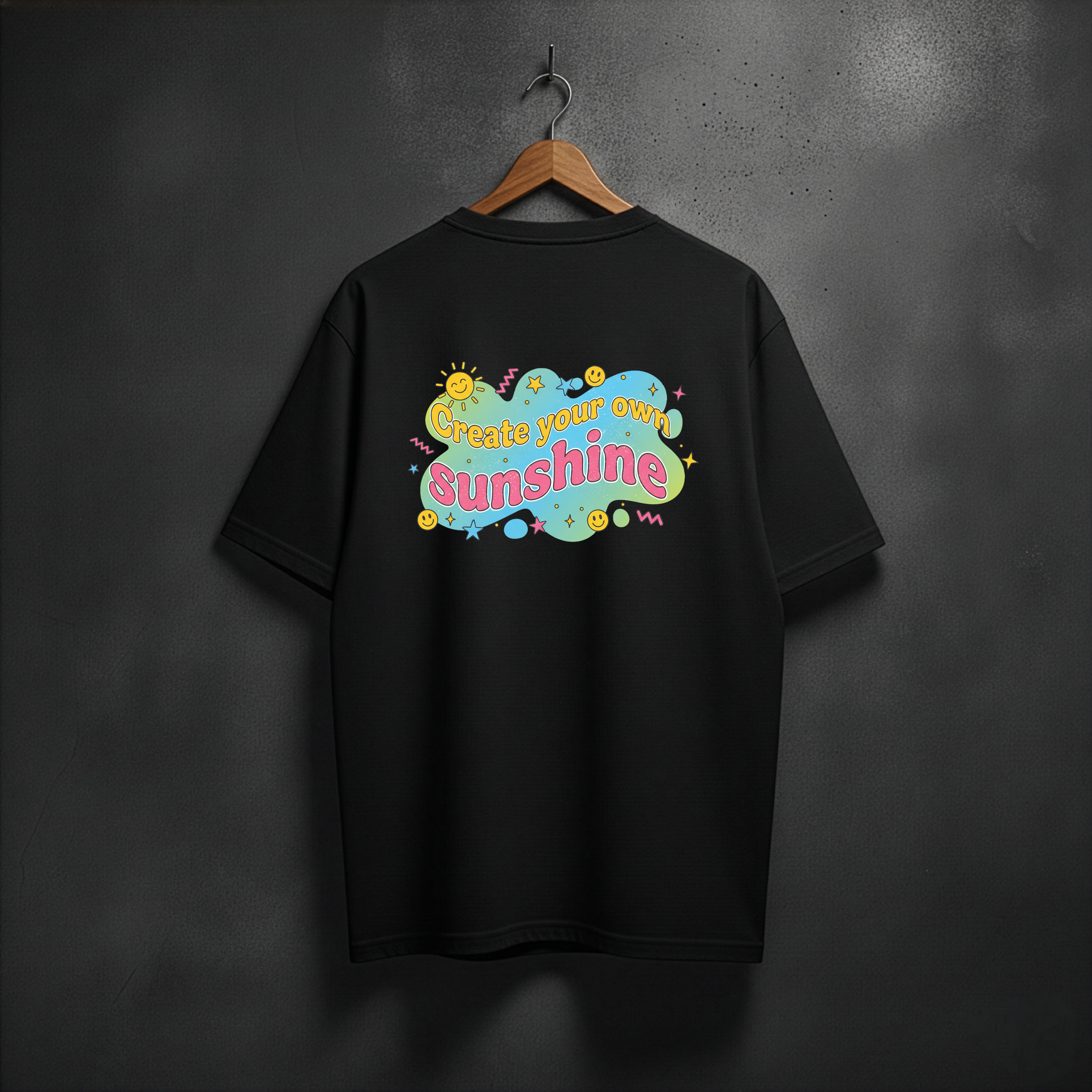 Black t-shirt with colorful  CREATE YOUR OWN SUNSHINE text design on the back