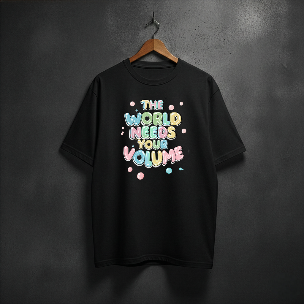 Black t-shirt with colorful text 'The World Needs Your Volume' on the front