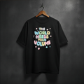 Black t-shirt with colorful text 'The World Needs Your Volume' on the front